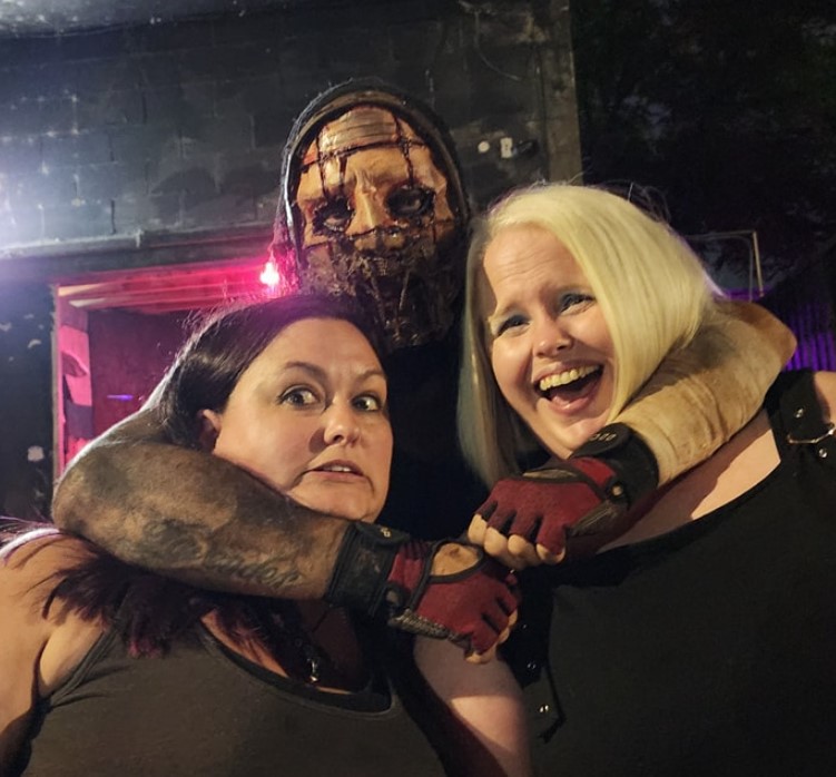 Haunted Hotel Actor Holding Nora and Tracy in a Headlock for a Photo Op