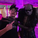 Photo of Tyler getting scared with a haunt actor
